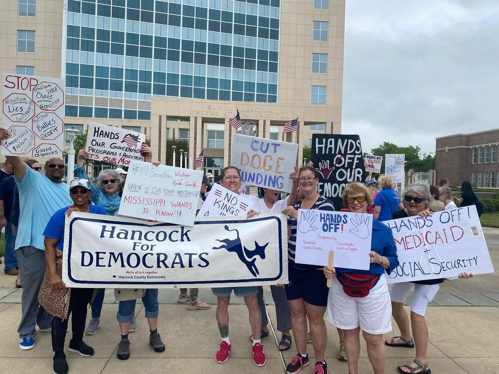 HCDEC members holding signs at a community event